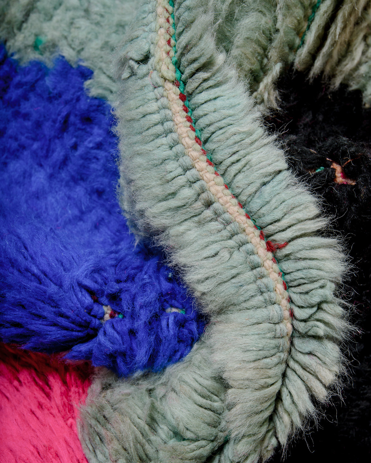 Detail of colourful wool of Berber rug showing the density of knots.